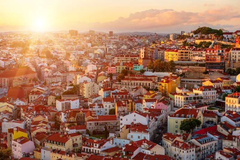 Lisbon, Portugal at sunset — historic terracotta rooftops of the capital city, the country's main international gateway and Atlantic hub